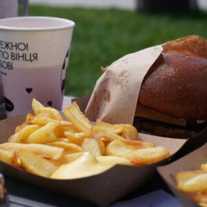 Enjoy a delicious grilled burger and fries in a casual outdoor setting.