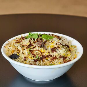 A flavorful biryani dish garnished with herbs and spices, perfect for food lovers.