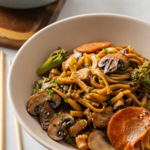 Delicious stir fry featuring mushrooms, carrots, and broccoli in a savory sauce.