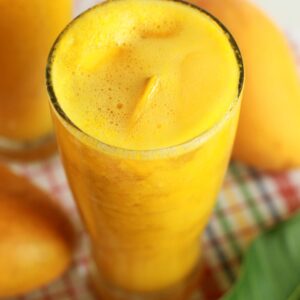 Chilled mango smoothie in a glass with tropical vibes, perfect for a sunny refreshment.